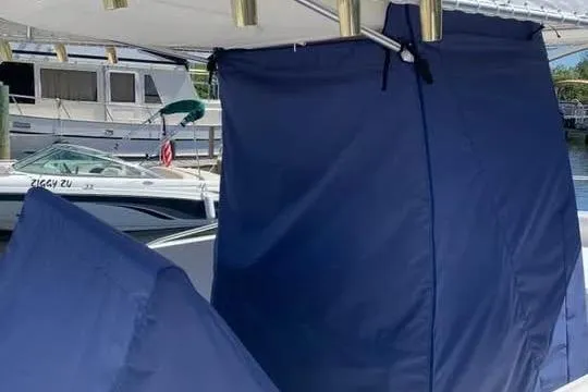Slide: The Image of 2005 Stamas 310 Tarpon boat with blue covers docked at a marina. - 3