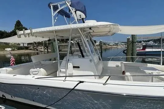 Slide: The Image of 2005 Stamas 310 Tarpon boat docked at a marina under clear blue skies. - 4