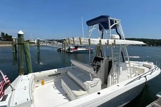 Slide: The Image of 2005 Stamas 310 Tarpon boat docked at marina under clear blue sky. - 8