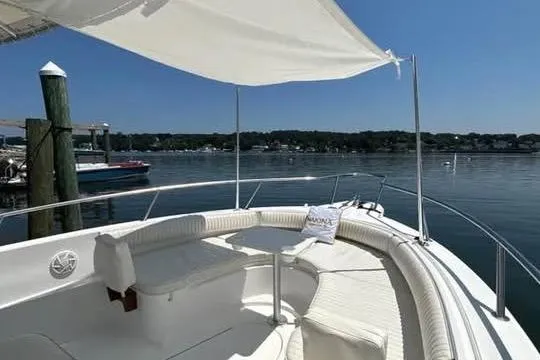 Slide: The Image of 2005 Stamas 310 Tarpon boat with shaded seating area, docked by calm waters. - 9