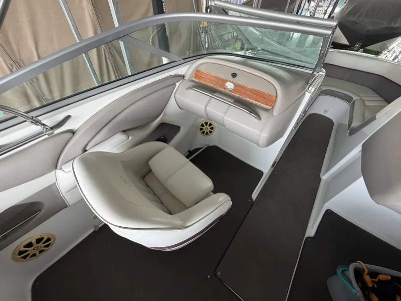 Slide: The Image of Interior of a 2004 Cobalt 220 boat with beige seating. - 10