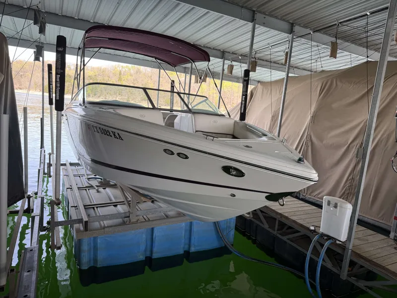 Slide: The Image of 2004 Cobalt 220 boat on a lift in a marina. - 15