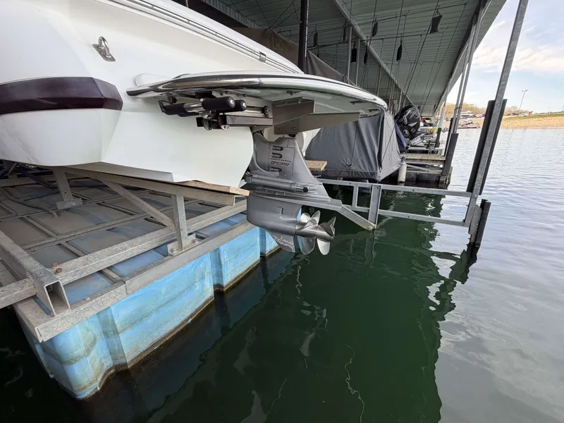 Slide: The Image of 2004 Cobalt 220 boat on a lift at the marina. - 16