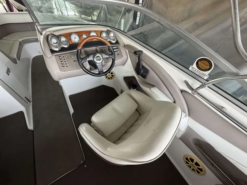 Slide: The Image of Interior of a 2004 Cobalt 220 boat with steering console and leather seat. - 7