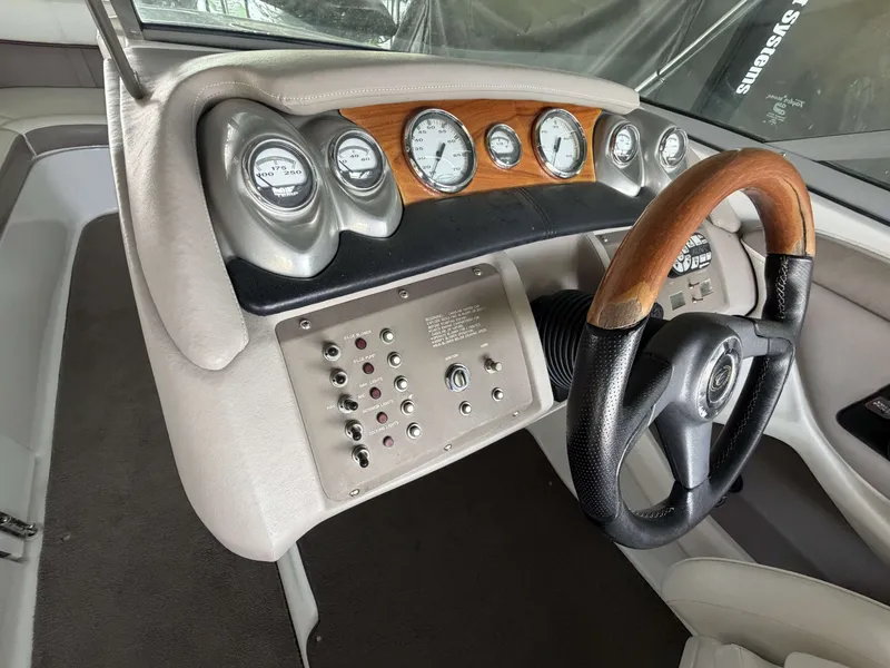 Slide: The Image of Dashboard of a 2004 Cobalt 220 boat with wooden steering wheel. - 8