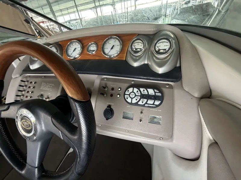 Slide: The Image of Dashboard of a 2004 Cobalt 220 boat with wooden steering wheel. - 9