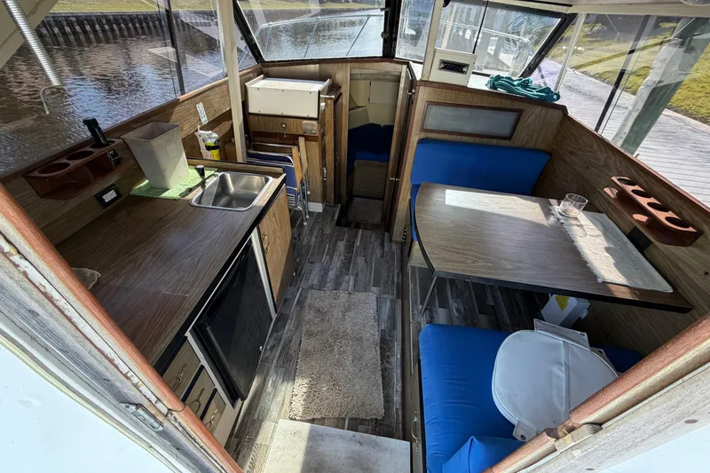Slide: The Image of Interior of a 1973 Chris-Craft 30 Tournament FB boat with kitchenette and seating area. - 10