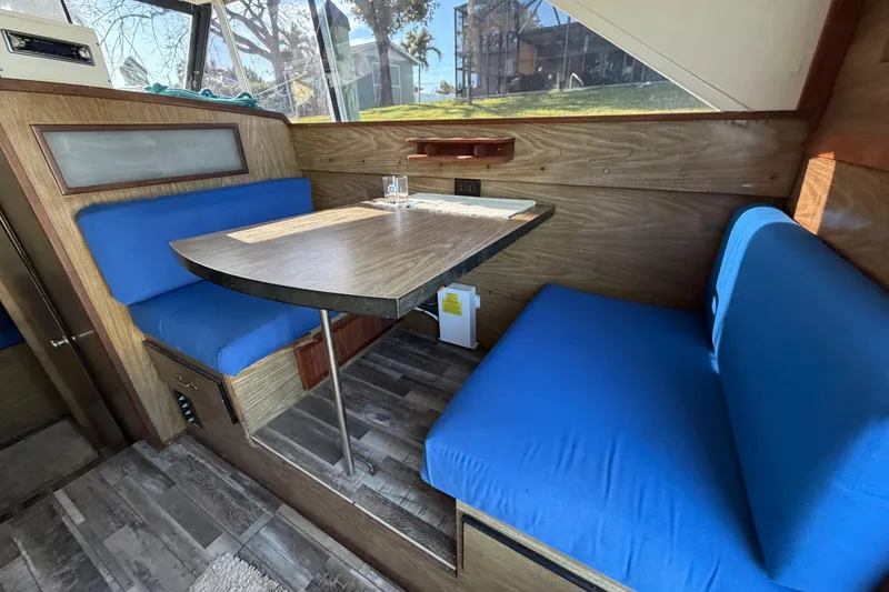 Slide: The Image of 1973 Chris-Craft 30 Tournament FB interior with blue seating and wooden table. - 13