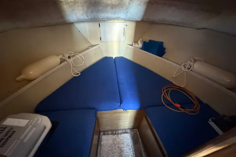 Slide: The Image of 1973 Chris-Craft 30 Tournament FB cabin interior with blue cushions and nautical equipment. - 16