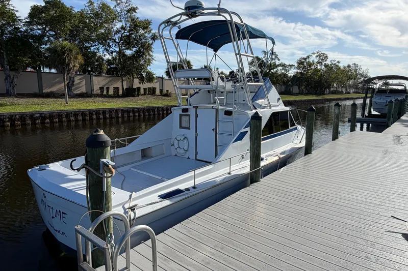 Slide: The Image of 1973 Chris-Craft 30 Tournament FB docked by a wooden pier on a sunny day. - 2