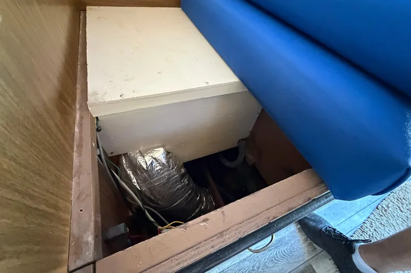 Slide: The Image of Interior view of a 1973 Chris-Craft 30 Tournament FB boat, showing storage compartment. - 22