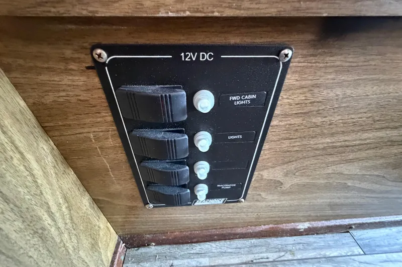 Slide: The Image of 1973 Chris-Craft 30 Tournament FB 12V DC panel with switches for cabin lights and pump. - 23