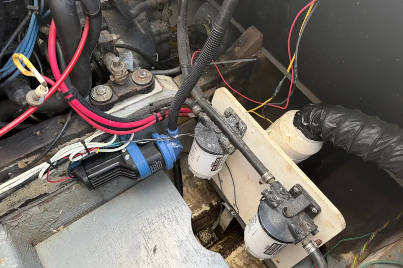 Slide: The Image of Engine compartment of a 1973 Chris-Craft 30 Tournament FB with wiring and fuel filters. - 31