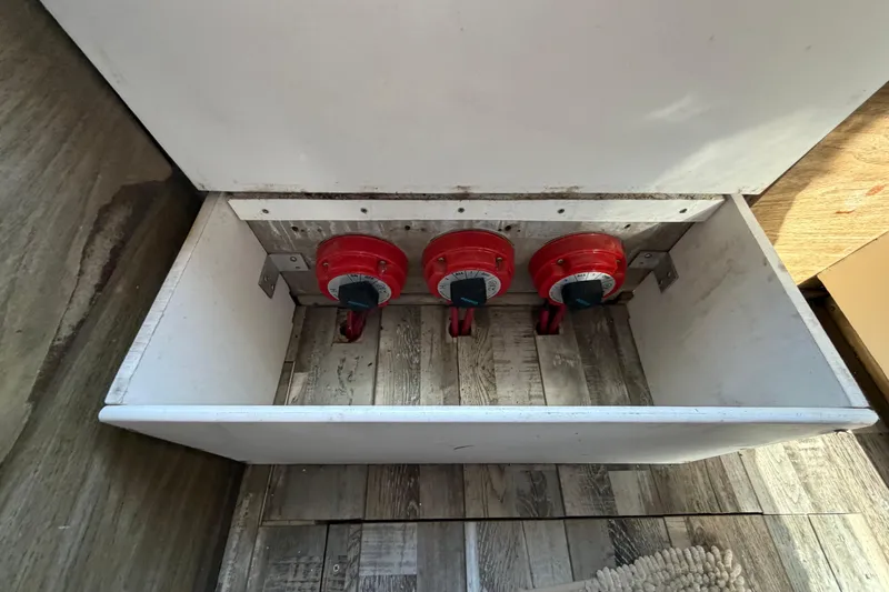 Slide: The Image of 1973 Chris-Craft 30 Tournament FB battery switches in a wooden compartment. - 12