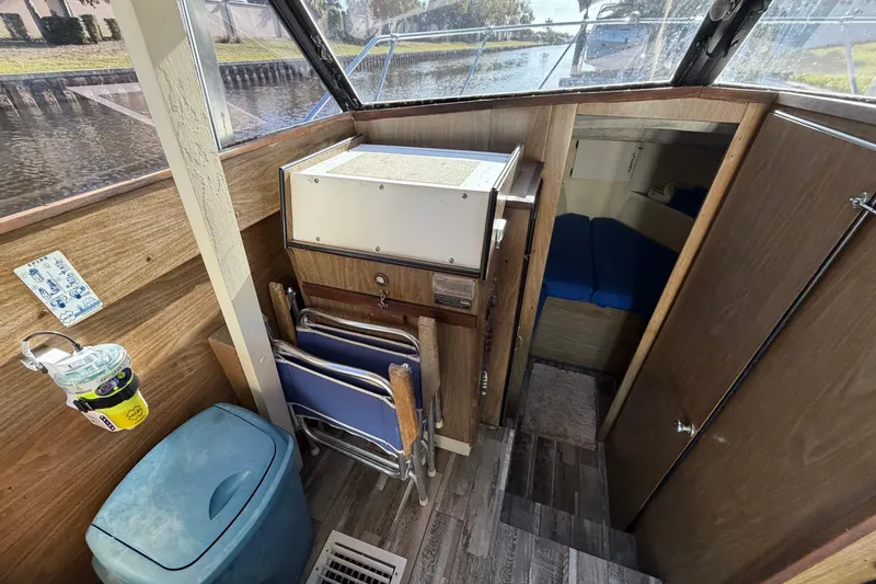 Slide: The Image of Interior of a 1973 Chris-Craft 30 Tournament FB boat with wooden paneling and seating. - 14
