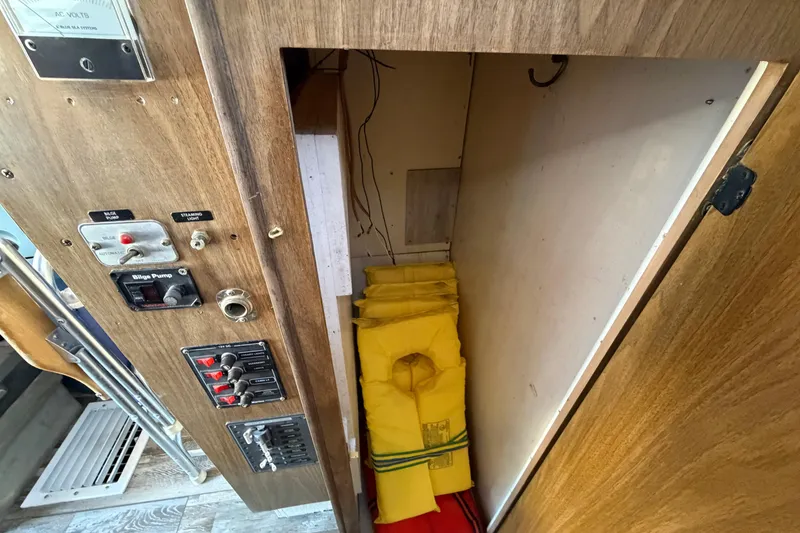 Slide: The Image of 1973 Chris-Craft 30 Tournament FB interior with life jackets and control panel. - 21