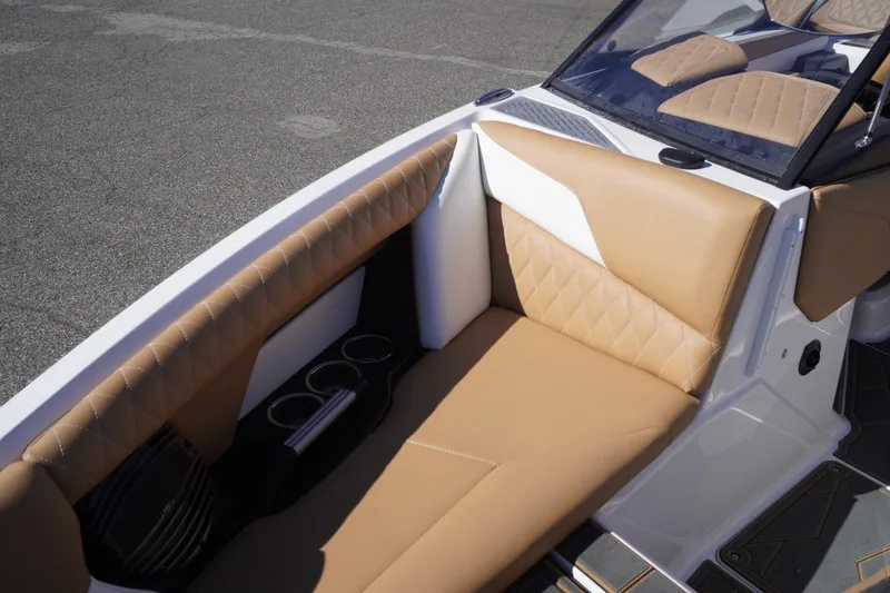 Slide: The Image of 2025 Tigé Z3 boat interior with tan quilted seating and cup holders. - 19