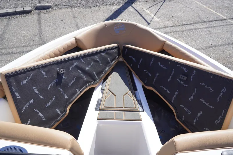Slide: The Image of 2025 Tigé Z3 boat interior with tan seating and branded storage covers. - 20