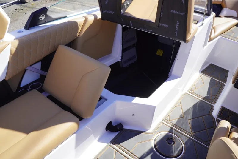 Slide: The Image of 2025 Tigé Z3 boat interior with tan seating and stylish flooring design. - 21