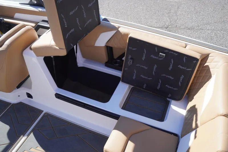 Slide: The Image of 2025 Tigé Z3 boat interior with tan seating and storage compartments open. - 22