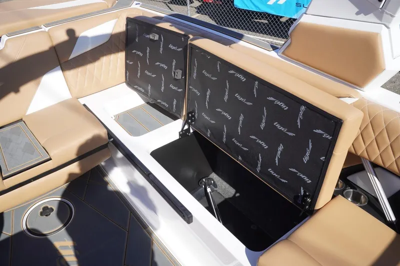 Slide: The Image of 2025 Tigé Z3 boat interior with tan seating and open storage compartment. - 23