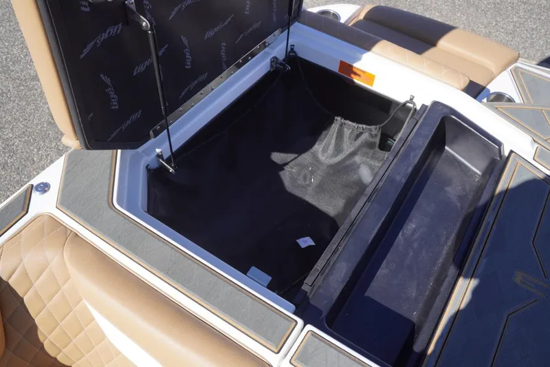 Slide: The Image of Open storage compartment in 2025 Tigé Z3 boat with tan seating and black interior. - 24