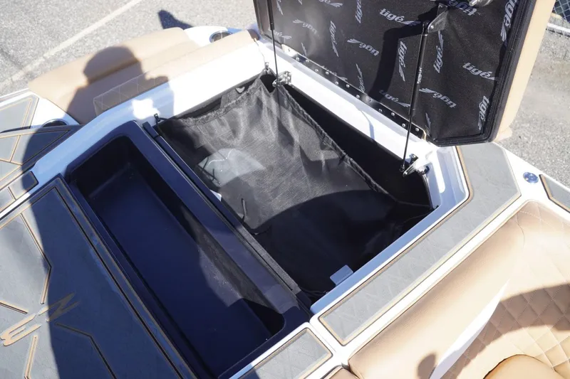 Slide: The Image of Open storage compartment in 2025 Tigé Z3 boat, showcasing interior design and materials. - 25