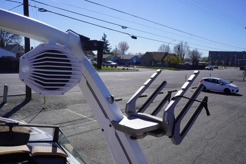 Slide: The Image of 2025 Tigé Z3 boat with wakeboard rack and speaker in a parking lot. - 27