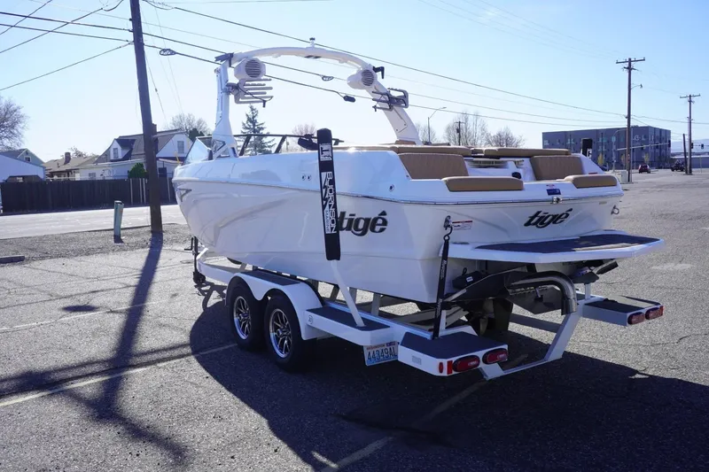 Slide: The Image of 2025 Tigé Z3 boat on trailer in parking lot, showcasing sleek design and modern features. - 7