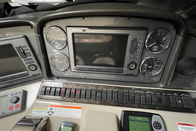 Slide: The Image of Dashboard of a 2007 Sea Ray 440 Express boat with gauges and controls. - 13