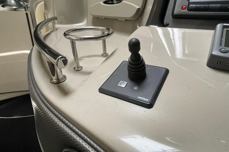 Slide: The Image of Control panel of a 2007 Sea Ray 440 Express boat with joystick and cup holder. - 15