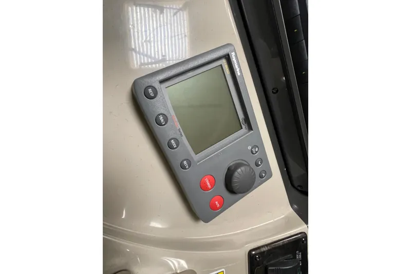 Slide: The Image of Control panel on a 2007 Sea Ray 440 Express boat, featuring navigation buttons and display. - 16