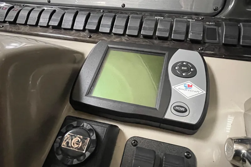 Slide: The Image of SmartCraft display on 2007 Sea Ray 440 Express dashboard with control buttons. - 17