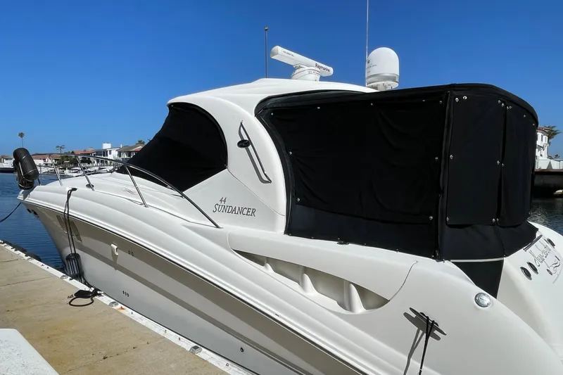 Slide: The Image of 2007 Sea Ray 440 Express Sundancer docked at marina under clear blue sky. - 2
