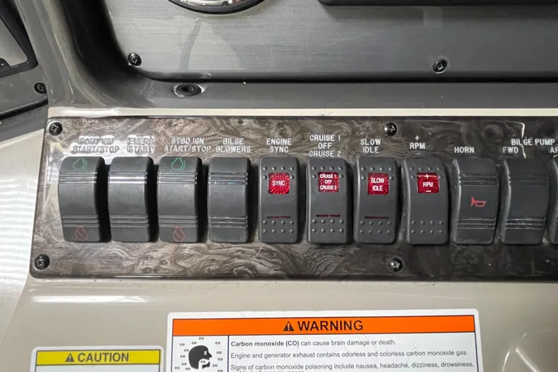 Slide: The Image of Control panel of a 2007 Sea Ray 440 Express boat with various switches and warning labels. - 21