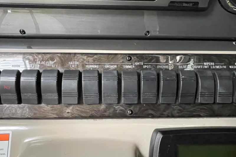 Slide: The Image of Control panel of a 2007 Sea Ray 440 Express boat with labeled switches. - 22