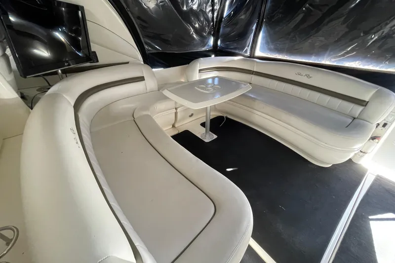 Slide: The Image of Luxurious interior of 2007 Sea Ray 440 Express yacht with white leather seating and table. - 27