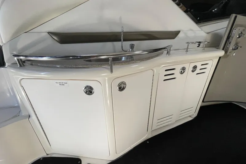 Slide: The Image of 2007 Sea Ray 440 Express yacht interior with sleek white cabinetry and chrome accents. - 30