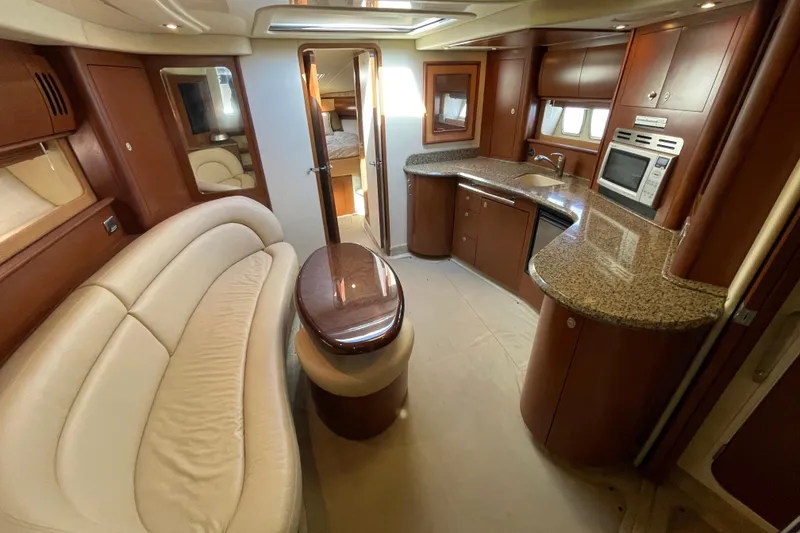 Slide: The Image of Luxurious interior of a 2007 Sea Ray 440 Express yacht with elegant seating and kitchen area. - 32
