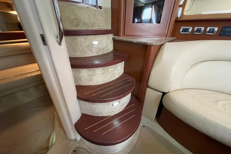 Slide: The Image of Interior of 2007 Sea Ray 440 Express yacht with elegant wooden stairs and plush seating. - 33
