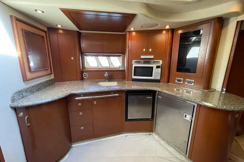 Slide: The Image of Luxurious 2007 Sea Ray 440 Express yacht kitchen with granite countertops and modern appliances. - 36