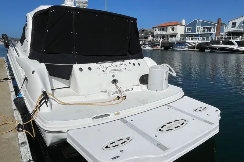Slide: The Image of 2007 Sea Ray 440 Express docked in a marina, featuring a covered deck area. - 4