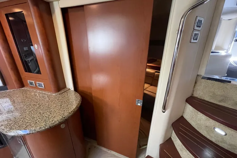 Slide: The Image of Interior of 2007 Sea Ray 440 Express yacht with wooden cabinetry and granite countertop. - 42