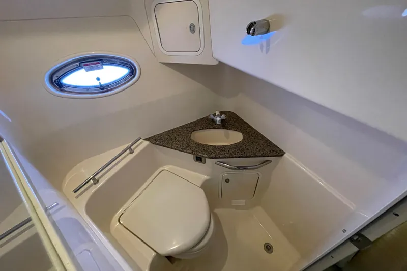 Slide: The Image of Luxurious bathroom in 2007 Sea Ray 440 Express yacht with modern fixtures and porthole window. - 44