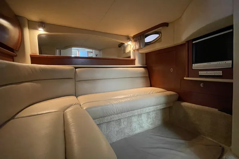 Slide: The Image of Luxurious interior of 2007 Sea Ray 440 Express yacht with beige seating and built-in TV. - 46