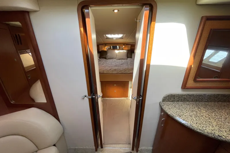 Slide: The Image of Interior of 2007 Sea Ray 440 Express yacht, featuring a cozy bedroom and elegant wood finishes. - 47