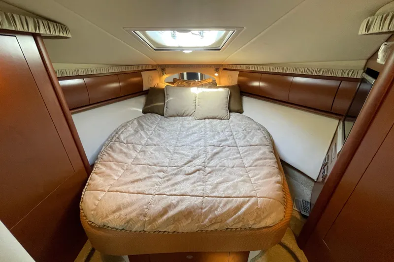 Slide: The Image of Luxurious cabin interior of 2007 Sea Ray 440 Express yacht with cozy bed and elegant wood finish. - 48