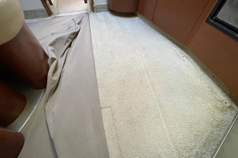 Slide: The Image of Interior view of a 2007 Sea Ray 440 Express with beige carpet and brown cabinetry. - 51