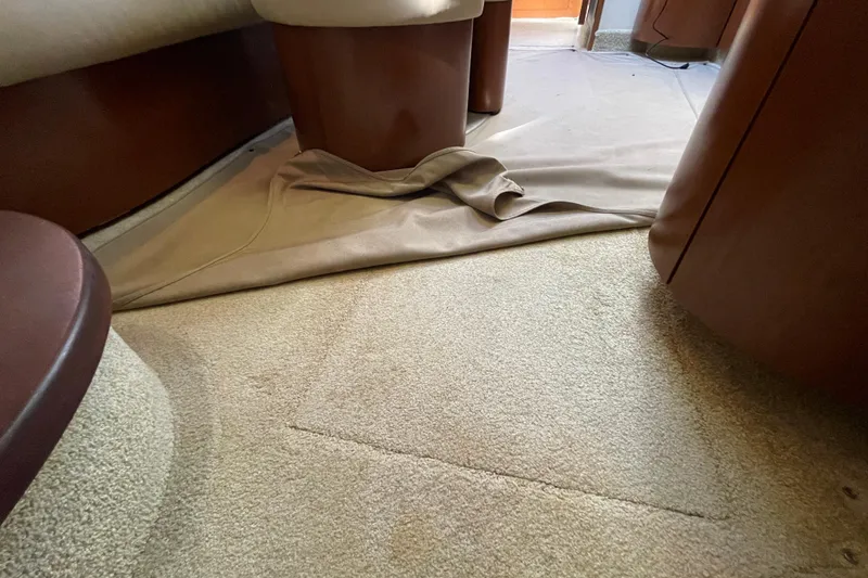 Slide: The Image of Interior of 2007 Sea Ray 440 Express with beige carpet and brown furnishings. - 52