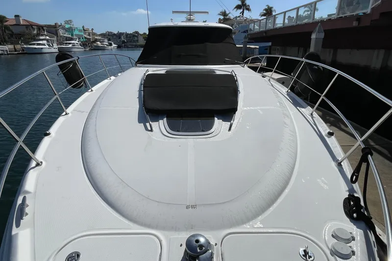 Slide: The Image of 2007 Sea Ray 440 Express yacht docked, showcasing sleek deck design and waterfront view. - 6